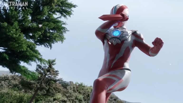 Ultraman Omega covering his eyes after killing Mikoto, expressing sorrow and reluctance rather than triumph
