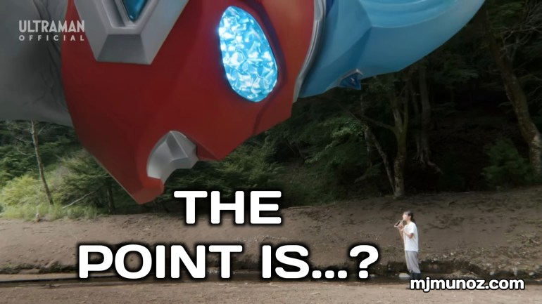 Ultraman Omega looks down at a lone person standing in a muddy clearing