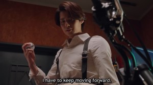 Baku holding the recovery capsem beside his rebuilt bike in Zeztz Episode 17