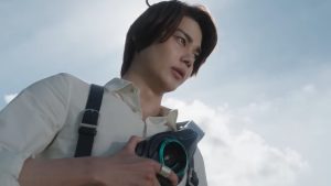 Baku holds the Zeztz Driver in Kamen Rider Zeztz episode 19 as he decides to keep fighting despite moral uncertainty