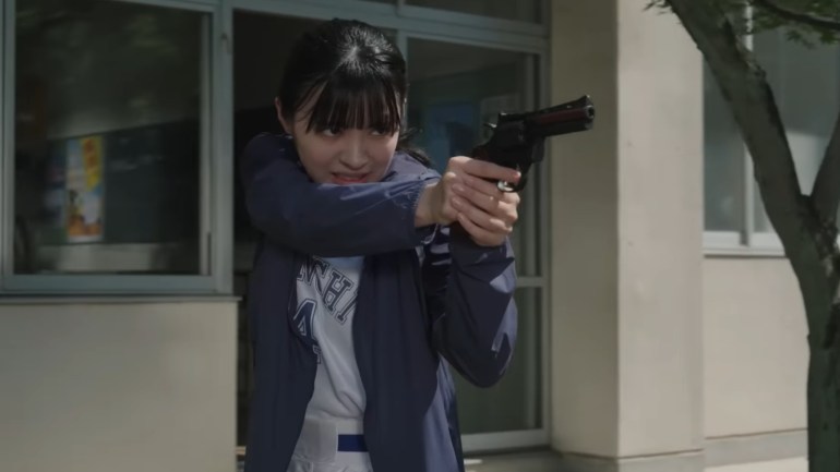 Kureha Miyamoto aims a handgun with both hands during Kamen Rider Zeztz Episode 18