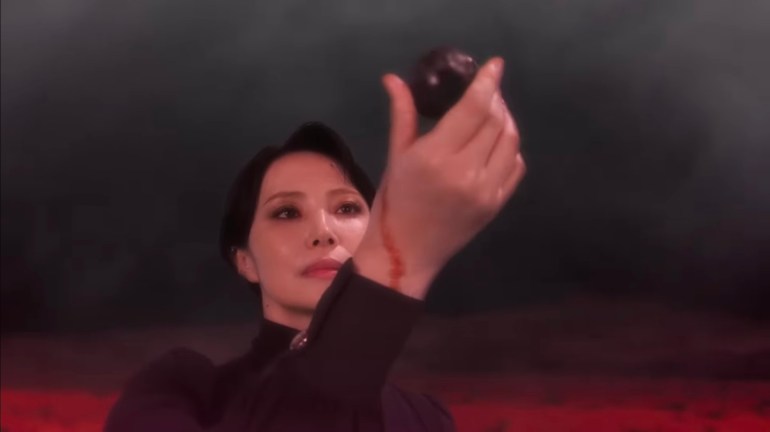 The Lady holds a Nightmare object in Kamen Rider Zeztz during an emotional and mysterious scene involving Nem and the Nightmares