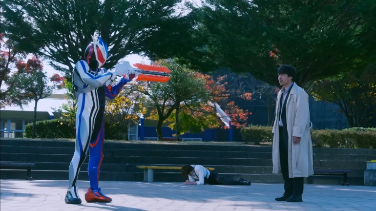 Nox aims his weapon at Fujimi during a tense confrontation in Kamen Rider Zeztz Episode 37.
