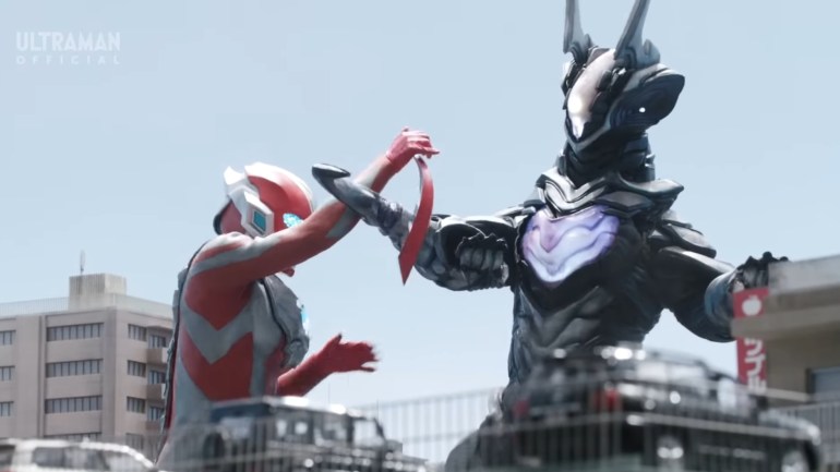 Ultraman Omega performs a clever combat maneuver against Zovaras during their battle in Episode 14, dropping and catching his slugger before striking his opponent.
