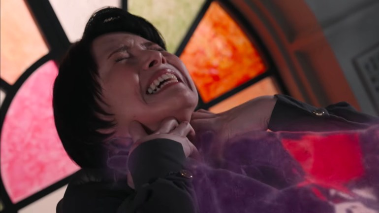 The Lady is choked by the Nightmare's dark power during a disturbing scene in Kamen Rider Zeztz Episode 38.