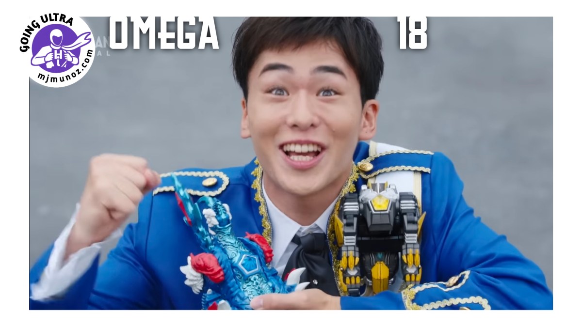 Kosei smiles excitedly while holding two Meteokaiju figures, wearing a blue uniform against a gray background.