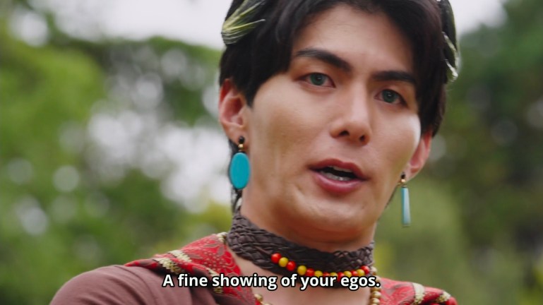 Close-up of Enkaku speaking outdoors with the subtitle, "A fine showing of your egos."
