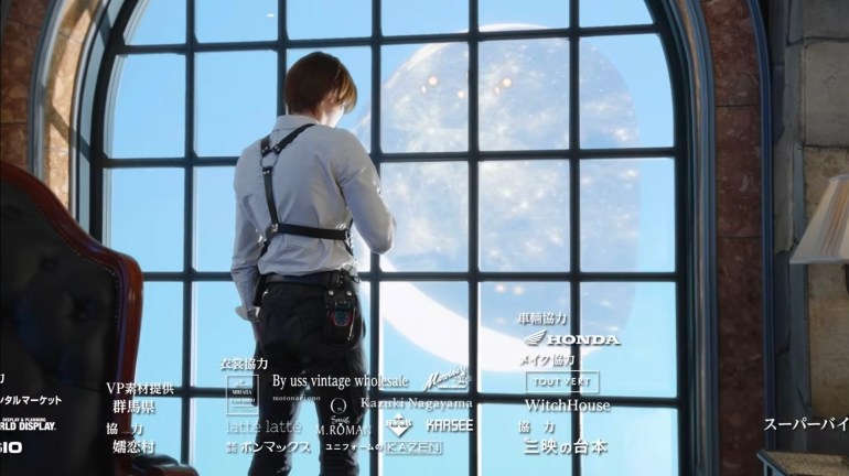 Baku stands with his back to the camera in front of a large arched window overlooking the Dream World.