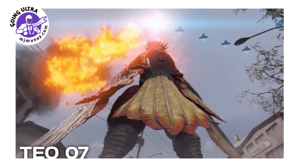 The giant bird kaiju Vermilios stands between buildings with a large explosion behind him and aircraft flying overhead.