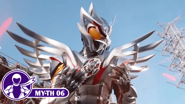 Kamen Rider My-Th in Eagle Frame, wearing silver armor with large feather-shaped wings, orange eyes, red accents, and clawed gauntlets against a blue sky.