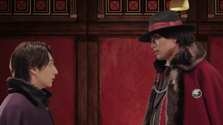 Asao stands across from Mao inside the Zodiac Alliance headquarters in Kamen Rider My-Th 04.
