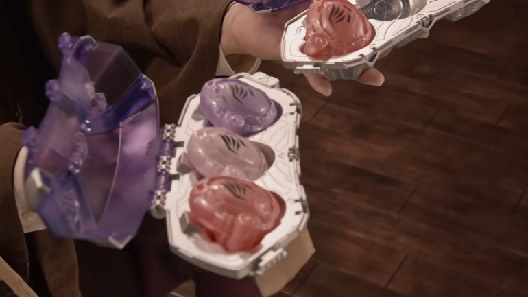 Four translucent Seed Eggz in red, pink, and purple sit inside white holders, with one additional Egg held above the open case.